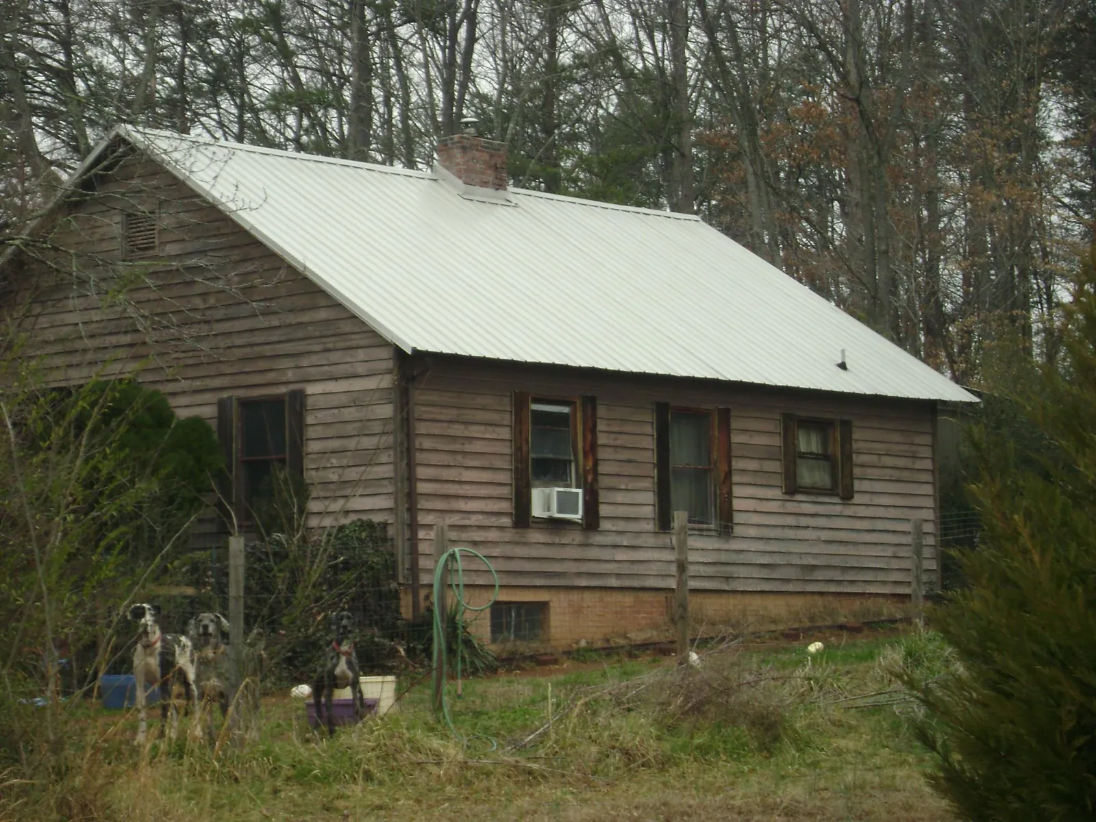 White metal roof on an old wood sided farmhouse, from a Metal Roof Installation job in Warrenville